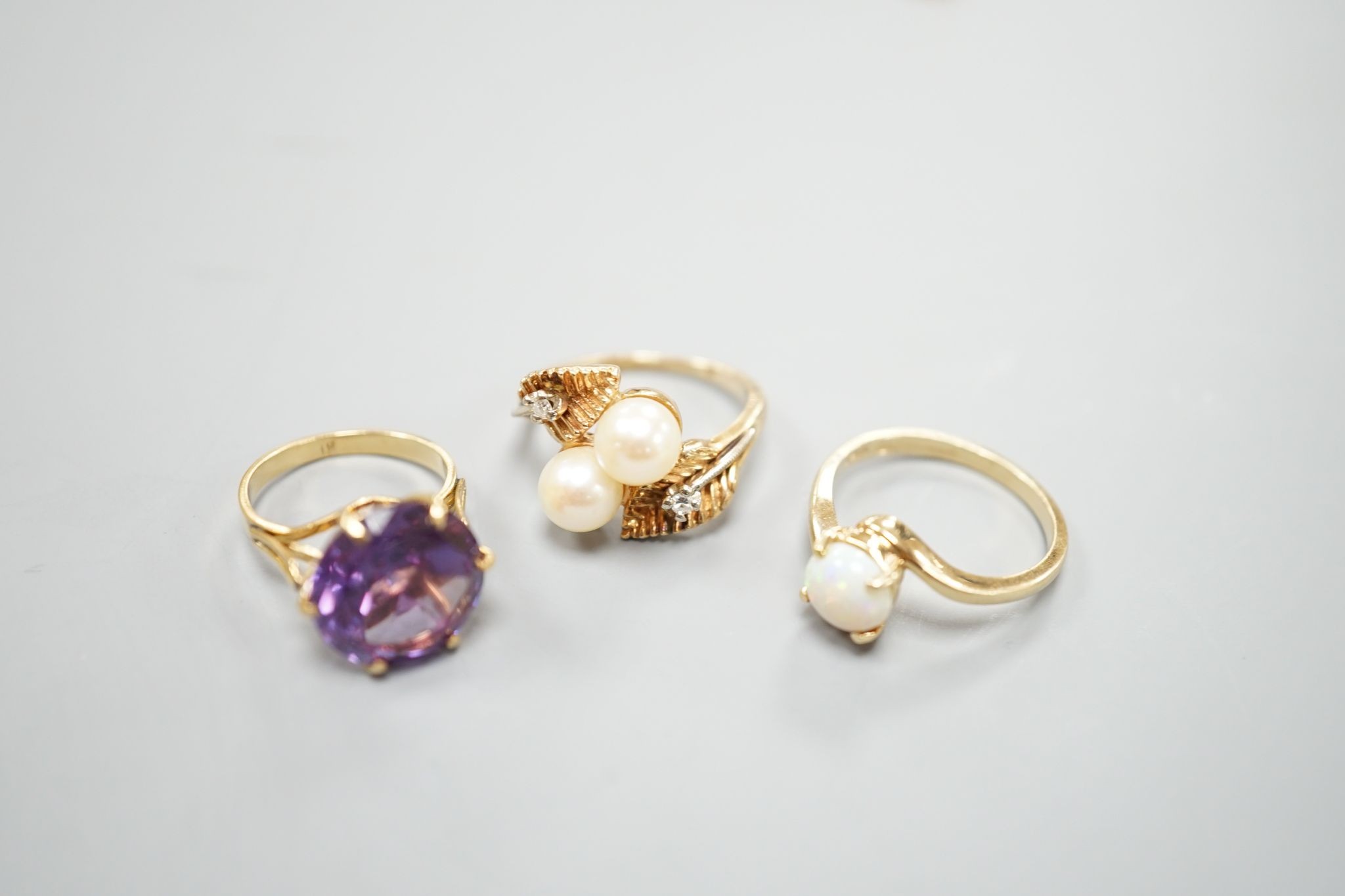 Three assorted modern 14k and gem set dress rings, including white opal, size L, gross 10.3 grams